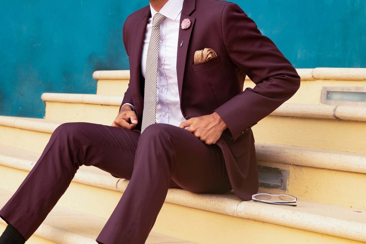 Person Sitting on Stairs Beside Sunglasses